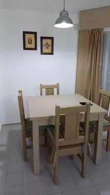a dining room table and chairs with a white table at tu lugar 1 in Cordoba