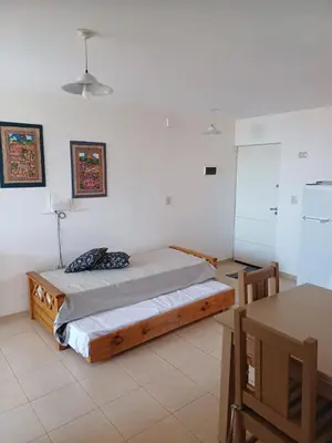 a bedroom with a bed in a white room at tu lugar 2 in Cordoba