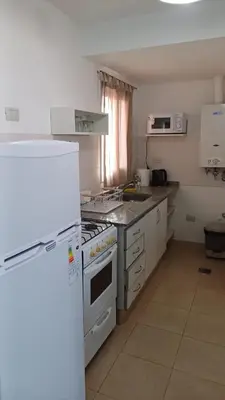 a kitchen with a white stove and a refrigerator at tu lugar 2 in Cordoba