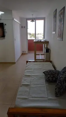 a room with two beds and a table in it at tu lugar 2 in Cordoba