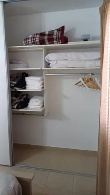 an open closet with towels and towels in a room at tu lugar 2 in Cordoba