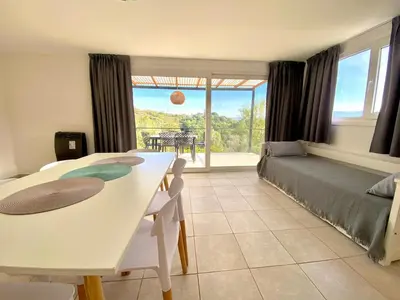 a living room with a bed and a table and chairs at Aire de las Sierras in Embalse