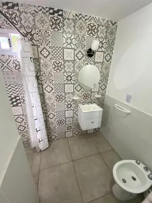 a bathroom with a white toilet and a sink at Aire de las Sierras in Embalse