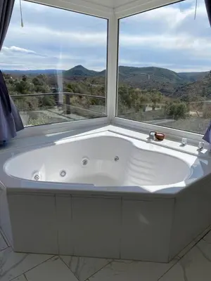 a white bath tub in a room with a window at Aire de las Sierras in Embalse