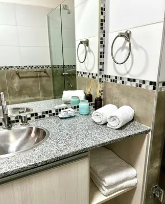 a bathroom counter with a sink and a mirror at Cabaña Sierras Chicas in Villa Anizacate