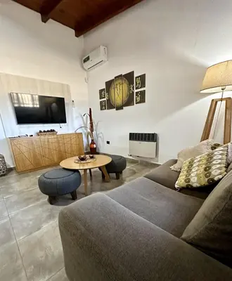 a living room with a couch and a table at Cabaña Sierras Chicas in Villa Anizacate