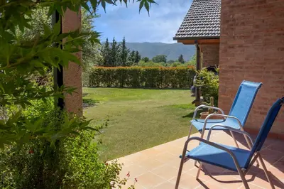a pair of blue chairs sitting on a patio at Cabaña para relajarse con vista panorámica in Villa General Belgrano