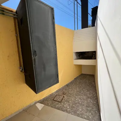 a door on the side of a yellow wall at Dorrego Departamentos in Villa Dolores