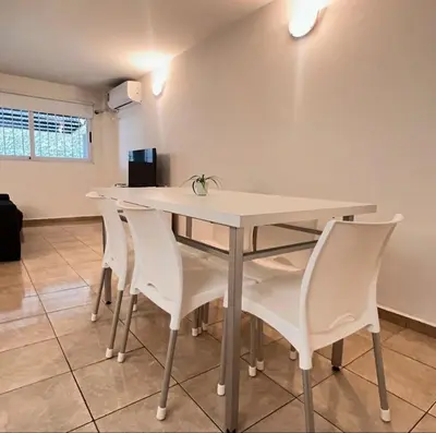a white table and chairs in a room at Dorrego Departamentos in Villa Dolores