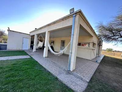 a house with a porch with a hammock outside at Casa Valle del colibrí in Cañada La Negra