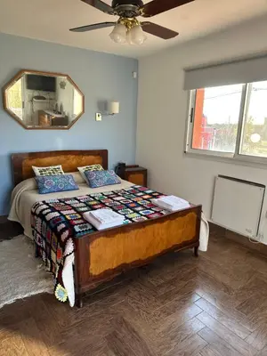 a bedroom with a bed and a ceiling fan at Casa Valle del colibrí in Cañada La Negra
