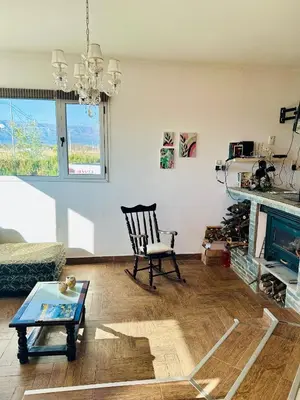 a living room with a chair and a fireplace at Casa Valle del colibrí in Cañada La Negra