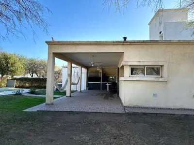 a building with an open garage with a slide at Casa Valle del colibrí in Cañada La Negra