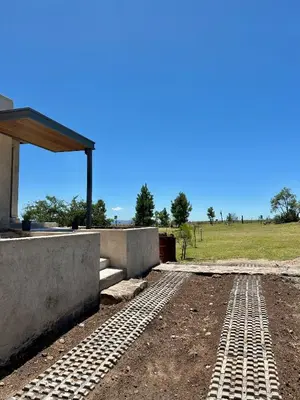 a foundation for a house with a field in the background at Cabañas Casa Flor Yacanto in Villa Yacanto