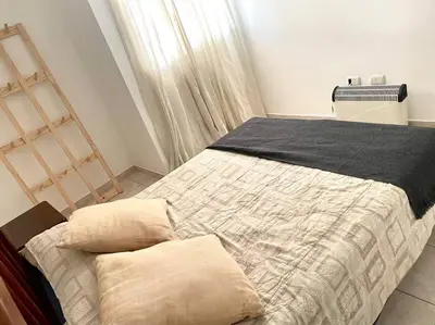 a bedroom with a bed with a black blanket at Departamento en Alberdi in Cordoba