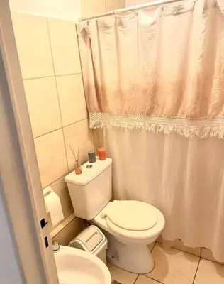 a small bathroom with a toilet and a sink at Departamento en Alberdi in Cordoba