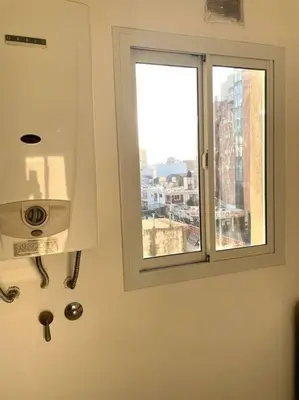 a window in a bathroom with a view of a city at Departamento en Alberdi in Cordoba