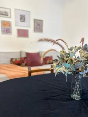 a vase of flowers sitting on top of a table at CASA Q Cba Zona Norte Kempes Aeropuerto Shopping cochera asador patio full equipada confortable in Cordoba