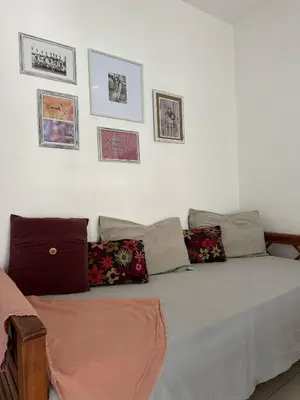 a bed in a room with pictures on the wall at CASA Q Cba Zona Norte Kempes Aeropuerto Shopping cochera asador patio full equipada confortable in Cordoba