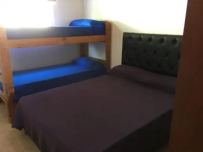 a bedroom with two bunk beds and a window at Depto temporario carlos paz in Villa Carlos Paz