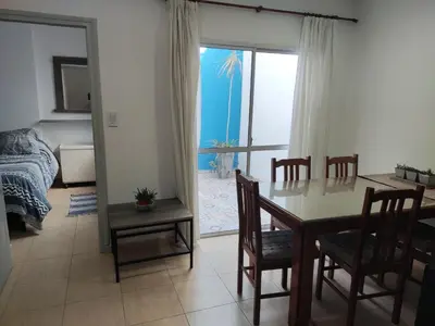 a living room with a dining room table and a bedroom at Velez Dpto in Río Tercero