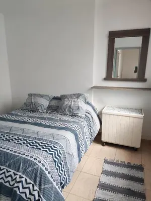 a bedroom with two beds and a mirror on the wall at Velez Dpto in Río Tercero