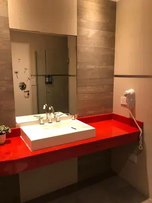 a bathroom with a white sink and a mirror at Cabañas Apart Margaridas in Merlo