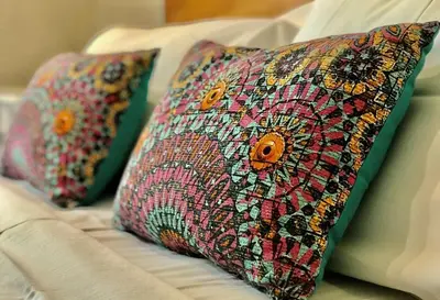 two pillows are sitting on a couch at Cabañas Apart Margaridas in Merlo