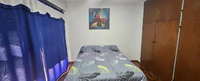 a bedroom with a bed and a picture of a butterfly at Departamento -Córdoba Capital- zona Centro in Cordoba