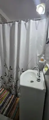 a bathroom with a sink and a shower curtain at Departamento -Córdoba Capital- zona Centro in Cordoba