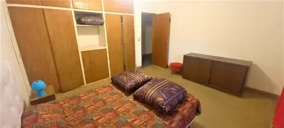 a bedroom with a bed with pillows and a tv at La Casona in Cordoba