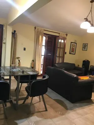 a living room with a table and a couch at Luis marcelo in Alta Gracia