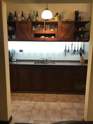 a kitchen with wooden cabinets and a counter top at Luis marcelo in Alta Gracia