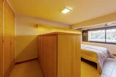 a small bedroom with a bed and a window at Departamento Centrico en Villa Carlos Paz in Villa Carlos Paz