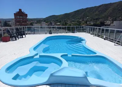 a blue swimming pool on the roof of a building at Sommet I in Villa Carlos Paz