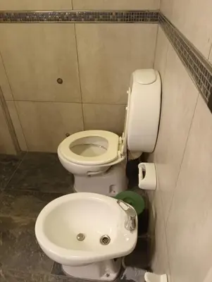 a bathroom with a toilet and a sink at Sommet I in Villa Carlos Paz