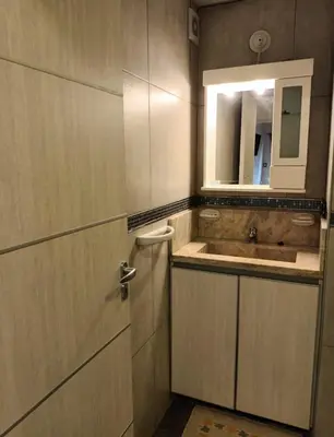a bathroom with a sink and a cabinet with a mirror at Sommet I in Villa Carlos Paz