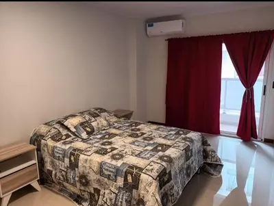 a bedroom with a bed and a red window at Sommet I in Villa Carlos Paz