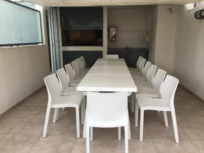 a conference room with a white table and white chairs at Balcarce Deluxe in Cordoba