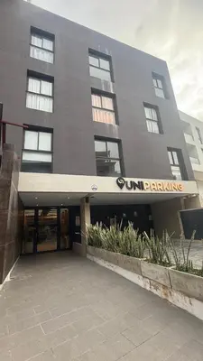 a building with a sun banking sign in front of it at Carlos Paz-Lake Towers in Villa Carlos Paz