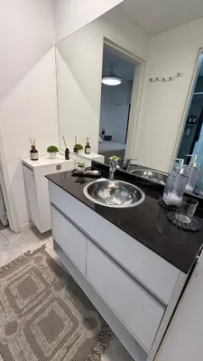 a bathroom with a sink and a large mirror at Carlos Paz-Lake Towers in Villa Carlos Paz