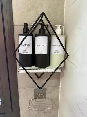 a shelf with three bottles on it in a bathroom at Carlos Paz-Lake Towers in Villa Carlos Paz