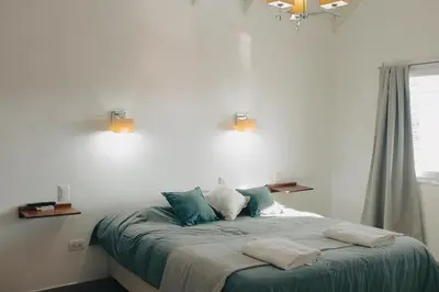 a bedroom with a bed with two towels on it at Jazmines Departamentos in Santa Rosa de Calamuchita