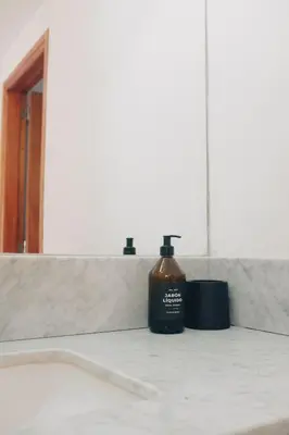 a bottle of soap sitting on a counter in a bathroom at Jazmines Departamentos in Santa Rosa de Calamuchita