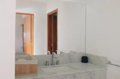 a bathroom with a sink and a mirror at Jazmines Departamentos in Santa Rosa de Calamuchita