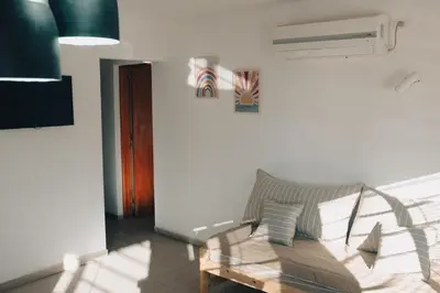 a living room with a couch and a table at Jazmines Departamentos in Santa Rosa de Calamuchita