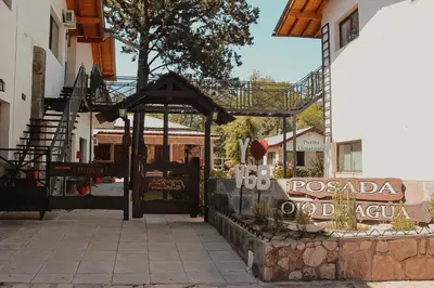 a entrance to a building with a gate and a sign at Posada Ojo de Agua Villa General Belgrano in Villa General Belgrano