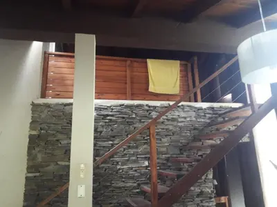 a staircase with a stone wall and a yellow towel at Brisas de Nono in Nono