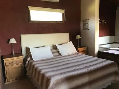 a bedroom with a large bed and a window at Brisas de Nono in Nono