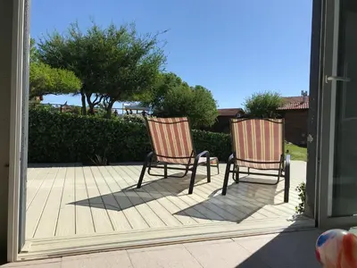 two chairs sitting on a deck in front of a mirror at Brisas de Nono in Nono